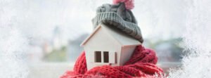 little house with winter hat and scarf wrapped around it
